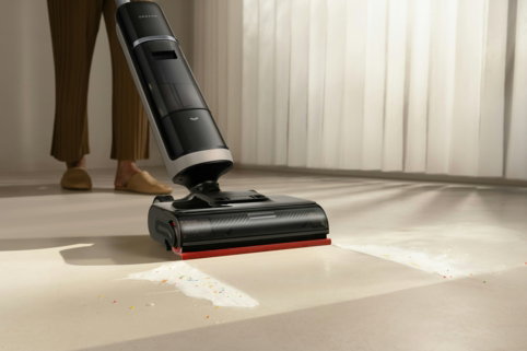 a-person-using-a-cordless-vacuum-cleaner-on-a-floor-.jpg A person using a cordless vacuum cleaner on a floor.